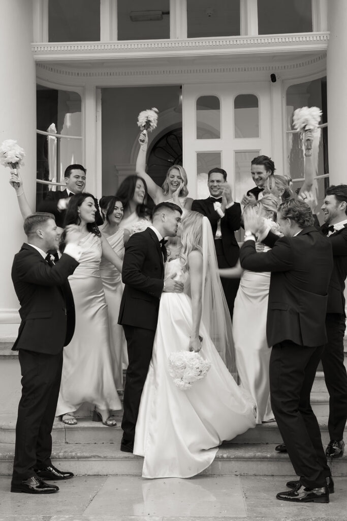 Newly married couple kissing in wedding outfits celebrating